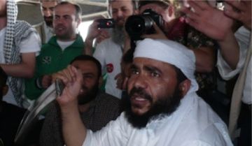 A left-wing activist on board the Gaza flotilla holding a knife after Israel Navy commandos boarded their ship on May 31, 2010.