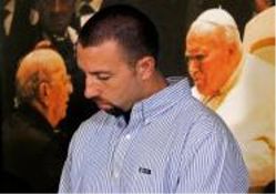 Jose Raul Gonzalez looks down during a news conference Monday, June 21, 2010 in St. Paul, Minnn., where a lawsuit was outlined on his behalf concerning the childhood abuse he alleges at the hands of his father, Rev. Marcial Maciel, who is shown at left in a photo with Pope John Paul II.