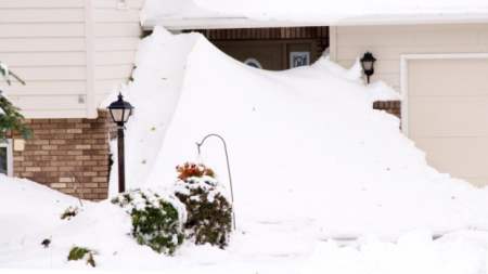 A front door of a home covered in a drift in Rapid City, S.D. 