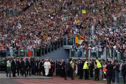 Pope Francis arrives for an encounter with more than 50,000 Catholic charismatics at the Olympic Stadium in Rome June 1. The pope knelt onstage as the crowd prayed over him by singing and speaking in tongues. 