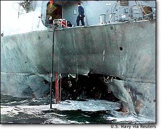 Image: Us Sailor Stands Atop Badly Damaged Uss Cole After Suspected Bomb Attack