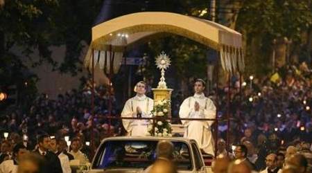 Two deacons ador Our Lord in the Eucharist in Francis' place.