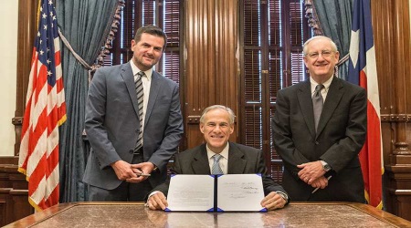 Texas Gov. Greg Abbott (center) signed a bill today that prevents taxpayers from having to pay for abortions through their insurance plans. 