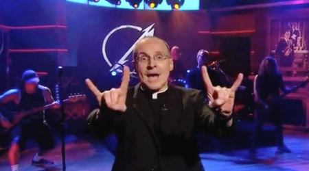 Fr. James Martin SJ sports double 'devil horns' to introduce Metallica on the Colbert Report, Sept. 24, 2013.