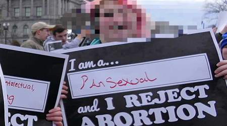 An attendee at the 2017 March for Life holds a sign declaring a 'pansexual' identity but opposition to abortion.