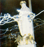 Taken at the February 10, 1973 vigil, photo taken of Our Lady of the Roses Shrine statue. But appearing miraculously upon the photograph, in the upper left-hand corner, in white Rosary bead formation appears the capital letter “G.” In the lower left base of Our Lady’s Shrine statue, in smallcase written style appear the words, “by sky.” The message of Heaven behind the photograph: capital “G” stands for God. We are told that that the chalice of God’s fierce wrath is about to be poured out upon humanity because of the sins of mankind in a great Chastisement. We are told, though, that before this Chastisement occurs, God will send to the world a Warning, a worldwide Warning, which will precede this Chastisement. This Warning will come directly from God and will come “by the sky,” an explosion in the sky. The sky shall roll back like a scroll, and the force of this explosion shall go into the very core of the person, and every person on earth will experience a revelation of their sins.