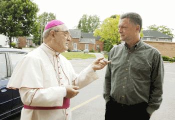 Bishop Nicola De Angelis and Jim Corcoran, a former openly homosexual altar server at St. Michael the Archangel Parish in Cobourg, in conversation Sunday following Mass at the church.