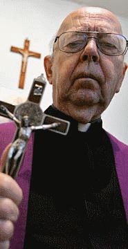 Father Gabriele Amorth with a St. Benedict Crucifix.