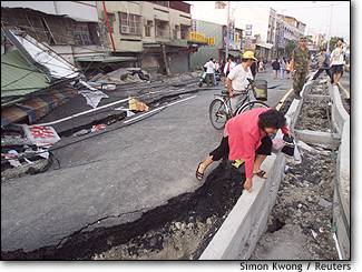 Image: Woman on damaged road