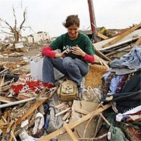 Melissa Hillhouse finds her camera salvageable among the remains of her home that were found across the street on Saturday May 5, 2007, after a tornado hit Greensburg, Kan. on Friday May 4, 2007.