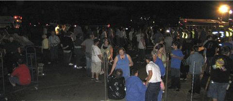 Survivors gather at a temporary command center in the parking lot of a partially destroyed grocery store in Greensburg, Kan. early Saturday morning, May 5, 2007.
