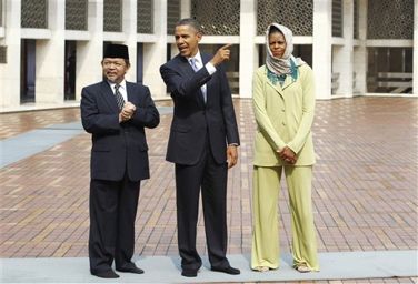 President Barack Obama and first lady Michelle Obama walk with Grand Imam Ali Mustafa Yaqub during their visit at Istiqlal Mosque in Jakarta, Indonesia, on Wednesday, Nov. 10, 2010.