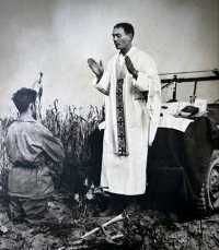Fr. Kapaun celebrates a field Mass on the hood of a jeep.