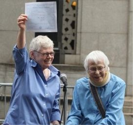 Connie Kopelov, 84 (R) and her wife Phyllis Siegel, 76, hold up a marriage certificate and celebrate