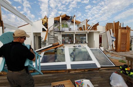 A friend helped neighbor move their belongings from a severely damaged house in Virginia Beach.