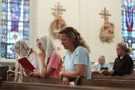 Jane Latz of Carthage, Ind., attends a recent Latin Mass at Holy Redeemer Catholic Church in Madison with her children Kristina, 16, center, and Theresa, 19. The family was passing through Madison on a vacation and sought out a Latin Mass.