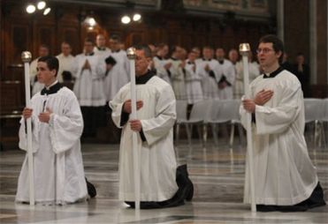 Altar servers kneel during Mass in the Extraordinary Form at the Basilica of St John Lateran in Rome