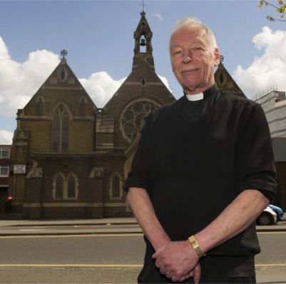 Father Donald Minchew outside St Mary's Catholic Church, Croydon, south London, where he has been based since he left the Church of England