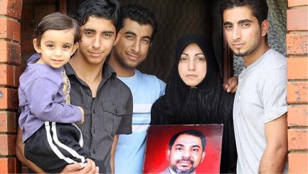 Mansor Almaribe's family members Wally (2), Mohammad, Jamal, Wafaa, and Isaam  with a photo of Mansor. 