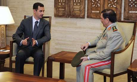 Bashar al-Assad greets his new defence minister on TV. 'When the �dictator has to appear on TV just to prove he�s alive, the end seems imminent.' 