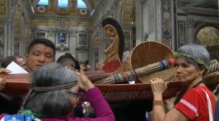A boat carrying a wooden statue of a naked woman with child ('Pachamama') is carried by indigenous people in St. Peter's Basilica during the opening ceremony for the Amazon Synod, Rome, Oct. 7, 2019. 