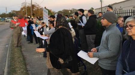 Catholics pray the rosary on Saturday outside Brash Brewery, where a satanic black mass was to take place later in the evening.