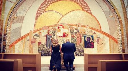 President and Mrs. Trump pray at the John Paul II National Shrine