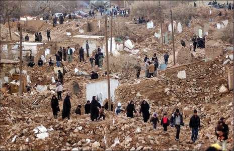 Iranians walked among the ruins of houses damaged by an earthquake early this morning in a village on the outskirts of Zarand, Iran. 